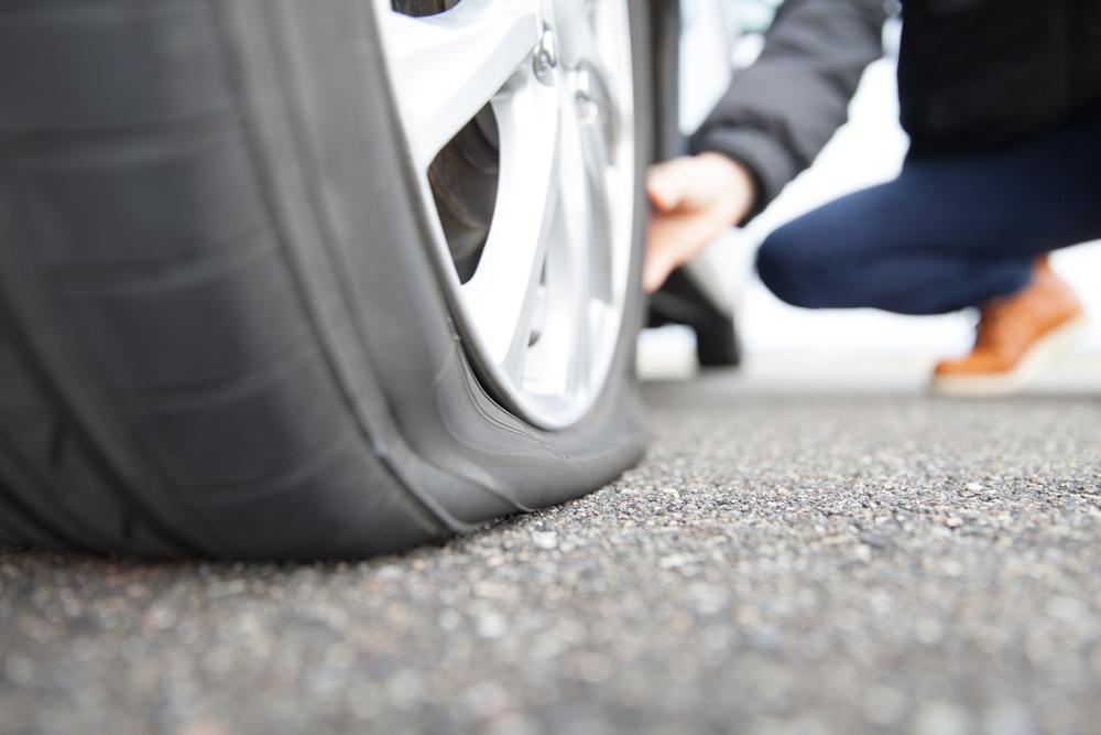 Flat tire change on the roadside in Woodstock
